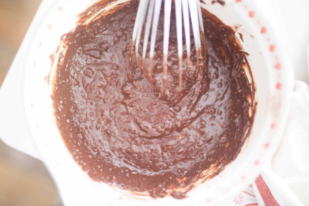 chocolate frosting in a white bowl.
