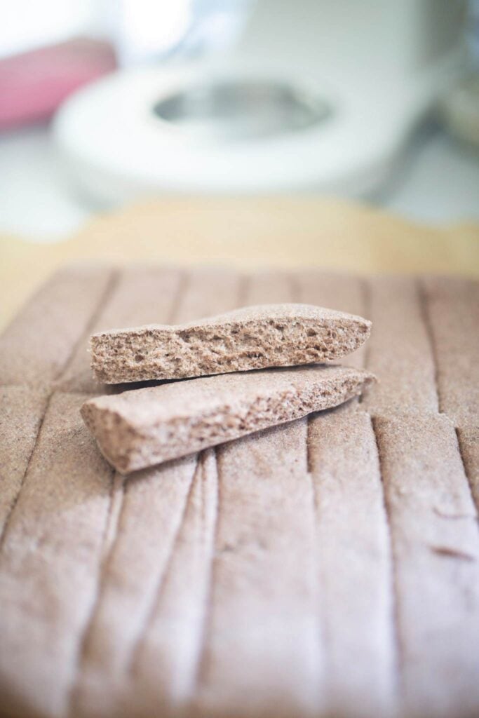 2 breadsticks sit on top of all the other breadsticks. Made with purple wheat they have a purple hue.