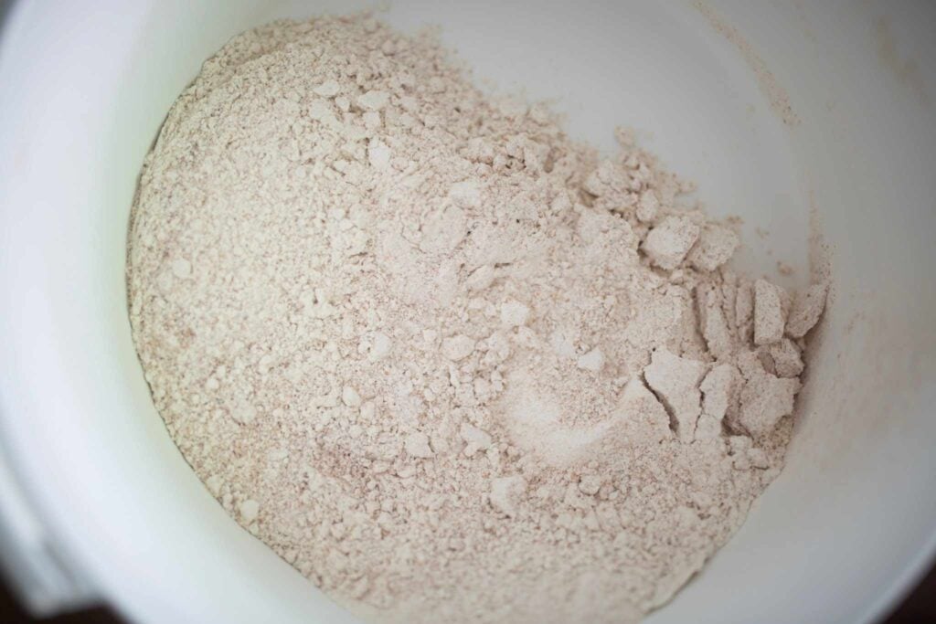 A big white bowl has flour in it.