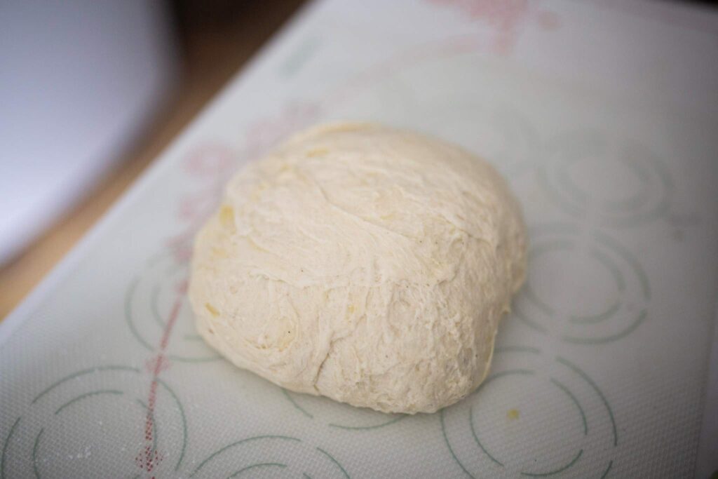 This is a ball of biscuit dough on a counter.