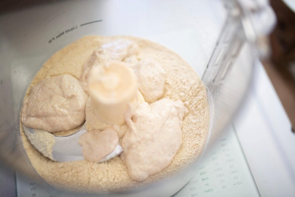 Flour and sourdough starter in a food processor.