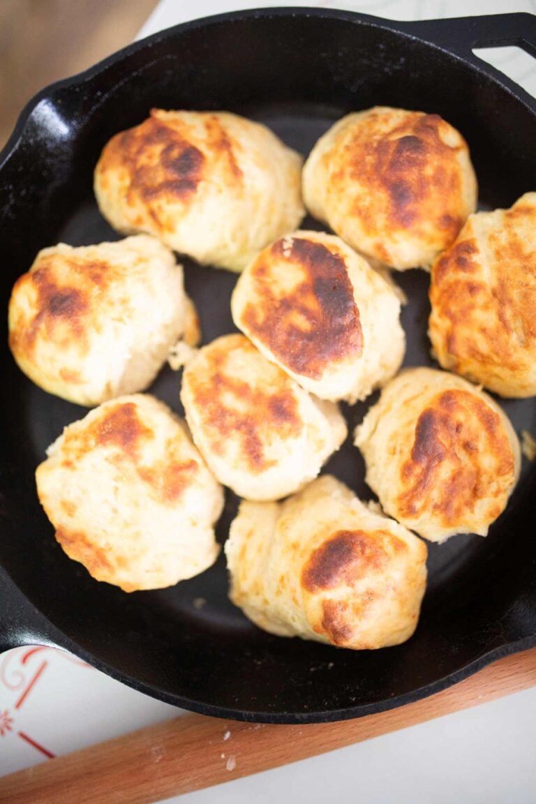 An overhead photo of biscuits in a cast iron skillet.