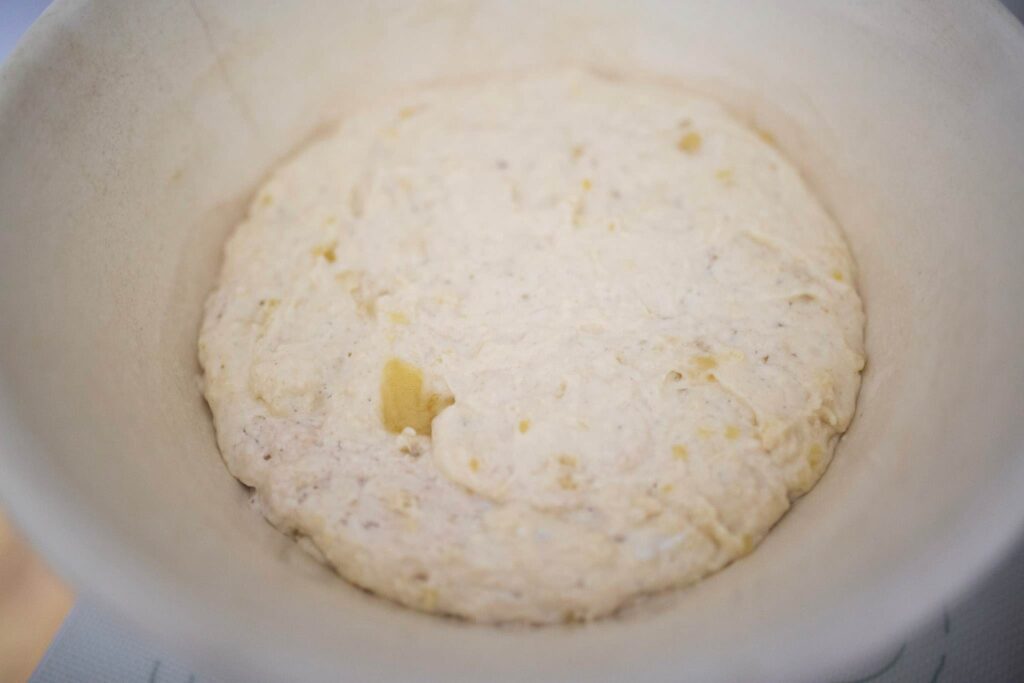 Biscuit dough is in a cream colored bowl.