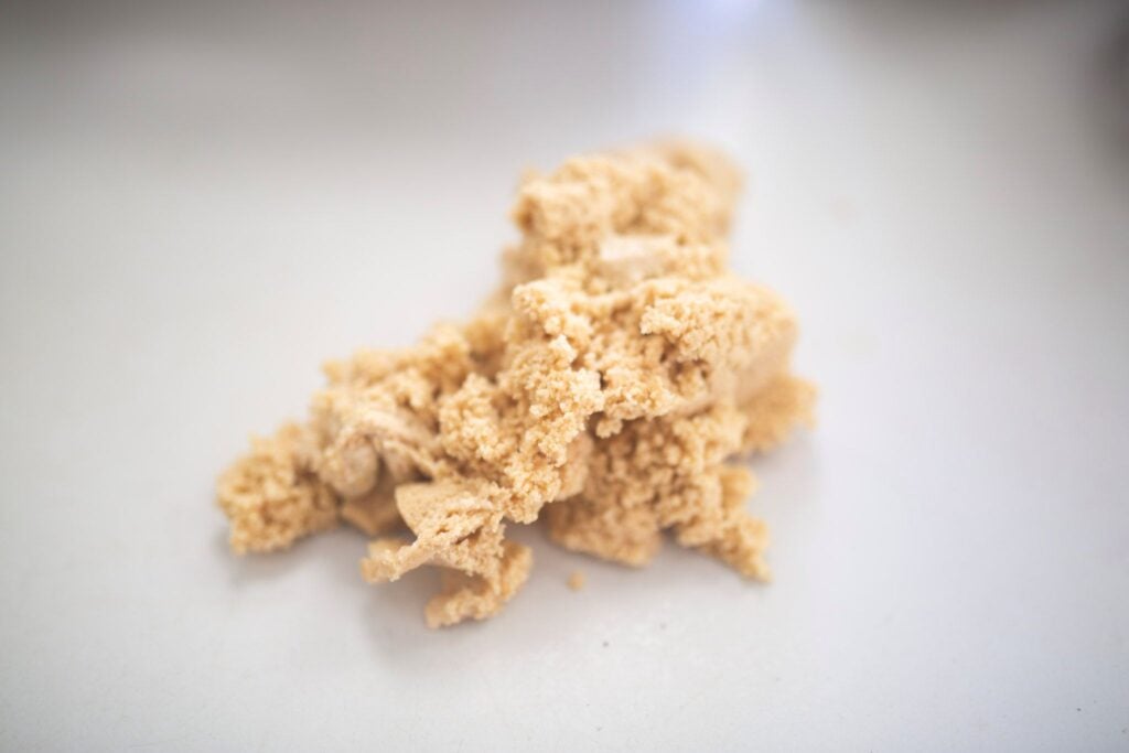 Rough, shaggy dough sits on a white plate.