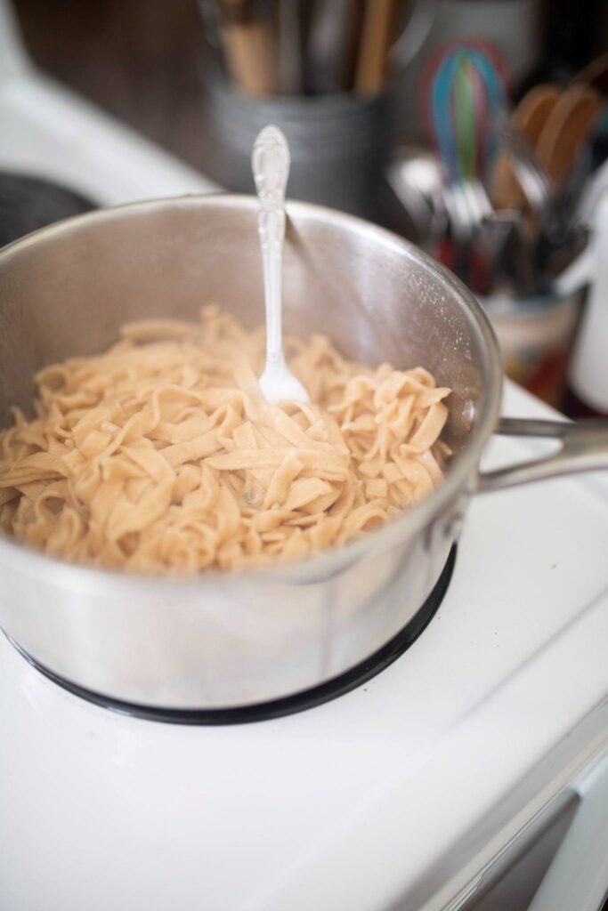 Pasta noodles cooking in boiling water.