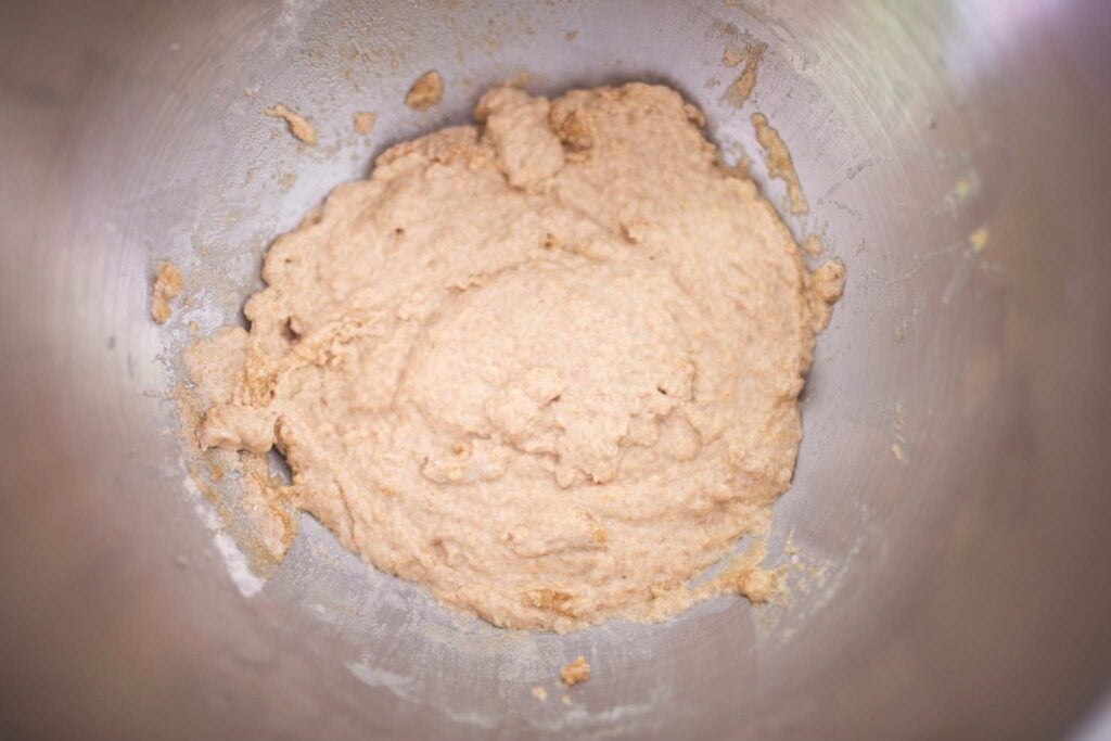A loose bread dough for a sponge method is in a bowl.