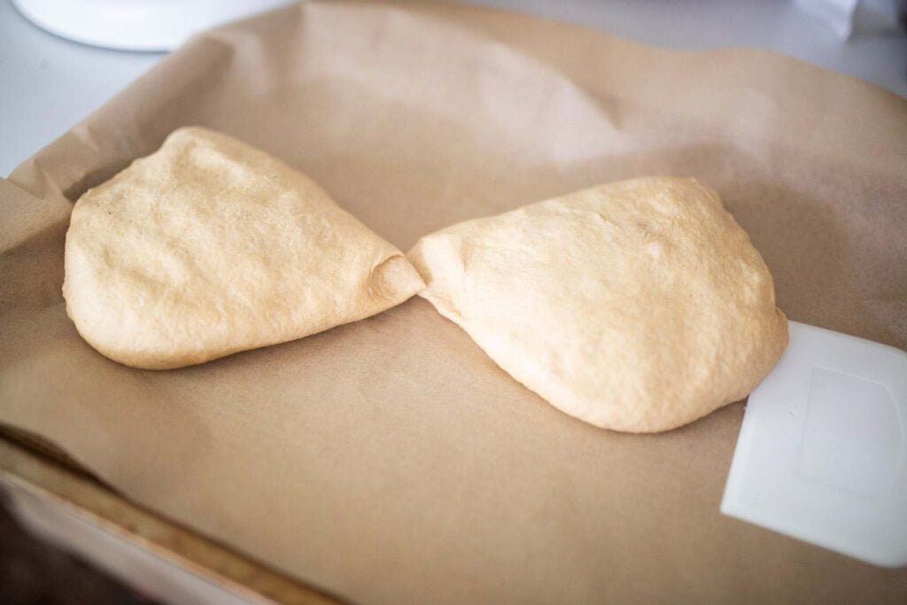 2 pieces of dough on a piece of parchment paper.